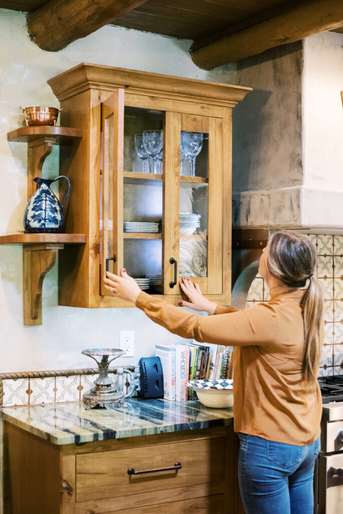 Interior design project of a kitchen in the Texas Panhandle featuring decorative tile backsplash, rustic wood, and cozy ambiance, as well as the interior designer herself!
